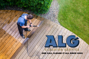 ALG employee cleaning a deck with a power washer
